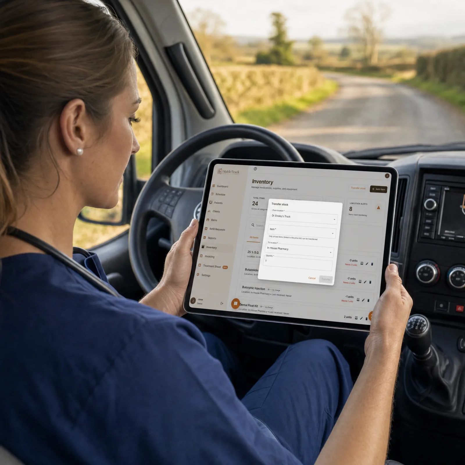 Equine veterinarian in a practice truck transferring stock between locations in StableTrack on a tablet